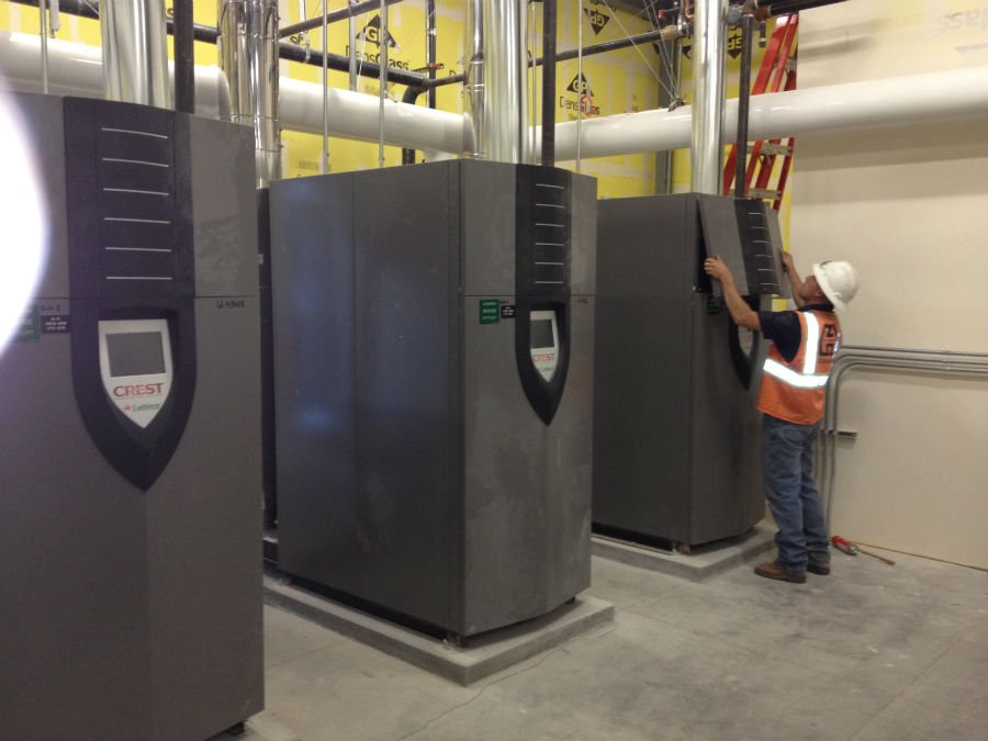 A worker working in a room full of machines